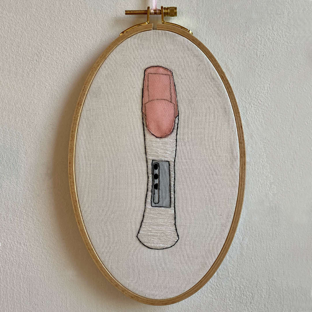 an embroidery of a pregnancy test