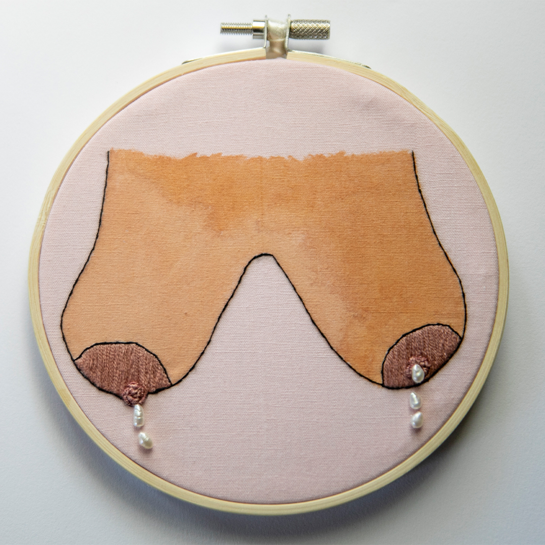 an embroidery of breasts leaking milk