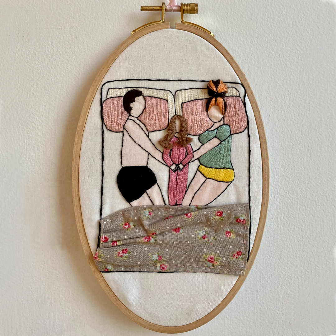 an embroidery of a family co sleeping