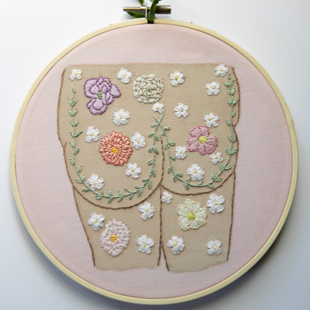 an embroidery of a butt with flowers on it
