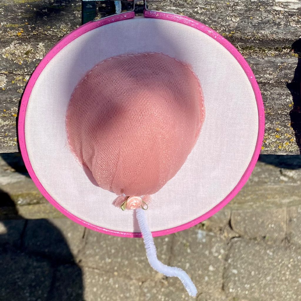 an embroidery that looks like a pink balloon