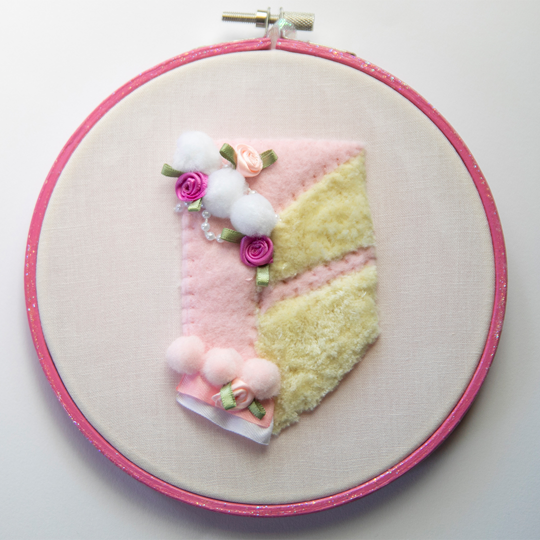 slice of cake embroidery in a pink glittery hoop